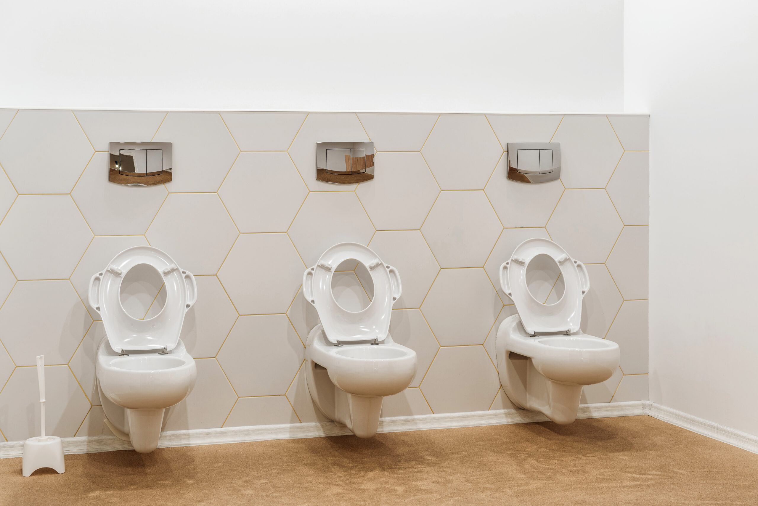 clean white toilet bowls in toilet in modern kindergarten