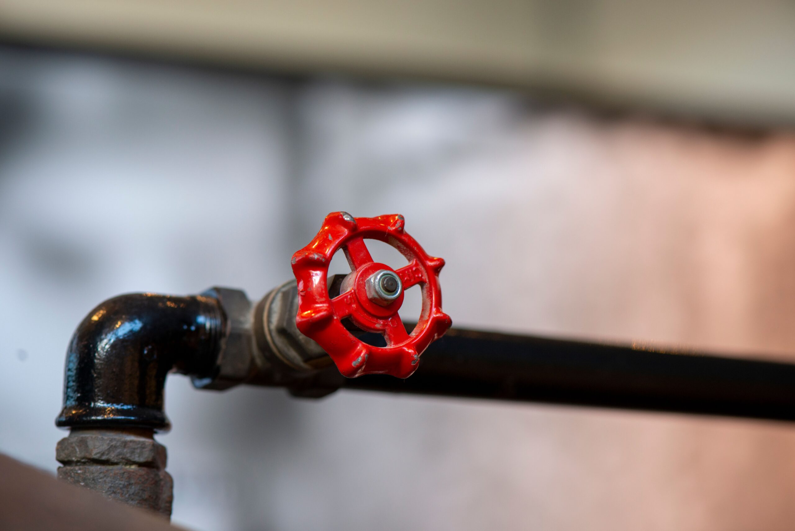 A closeup shot of a Bright red industrial valve