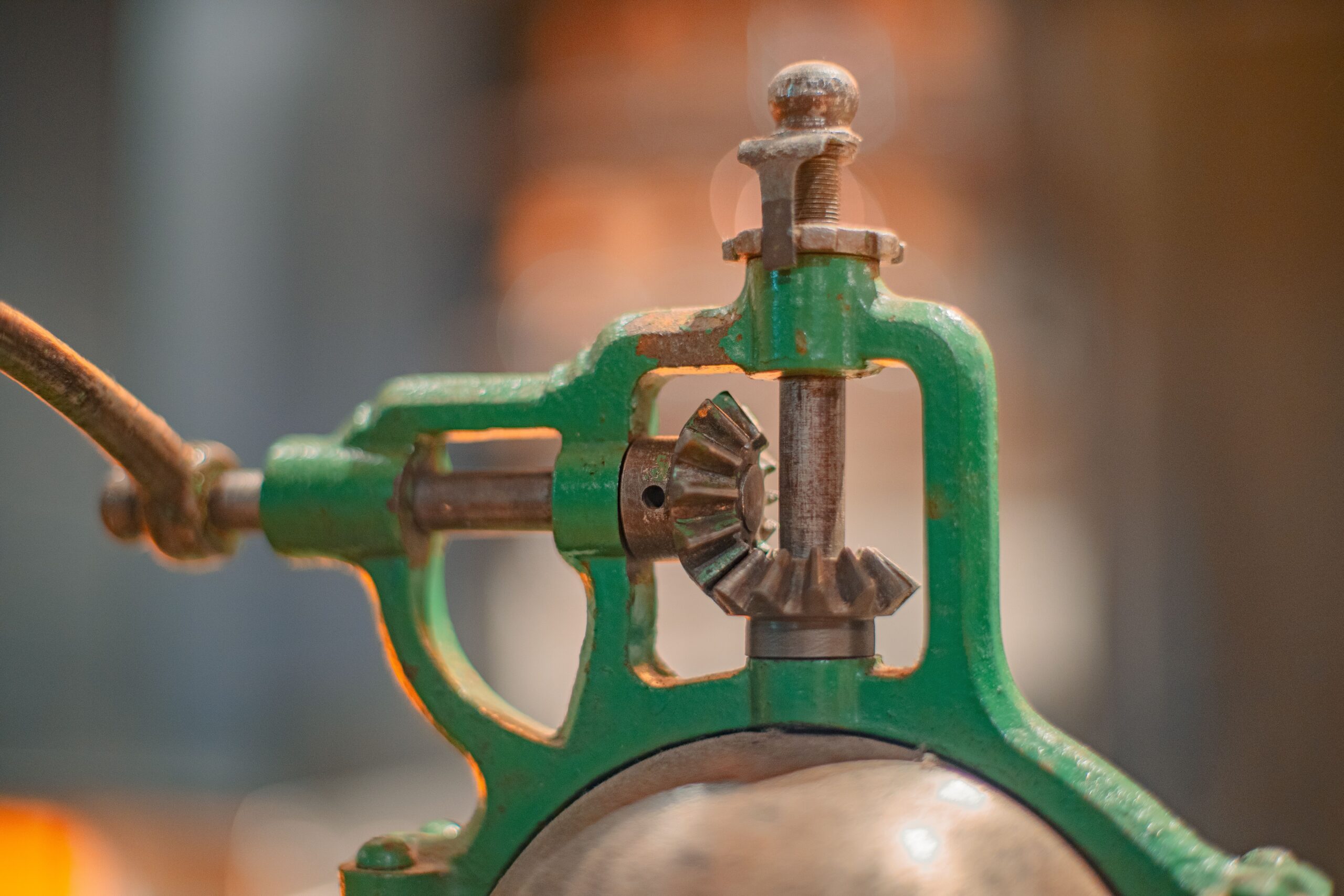 A green fire extinguisher with a metal pipe spout